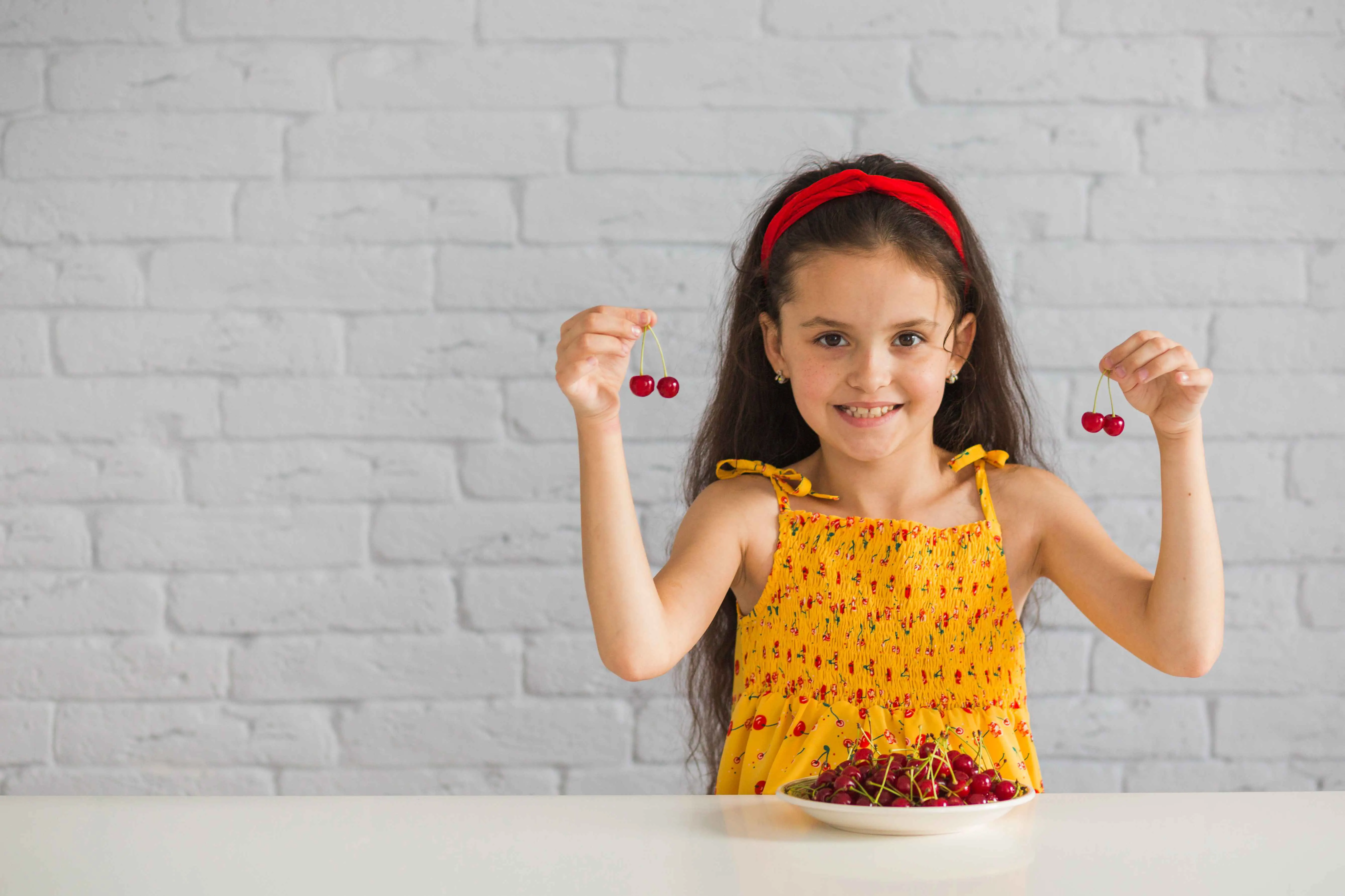 smiling-girl-holding-red-cherries-her-hand_11zon